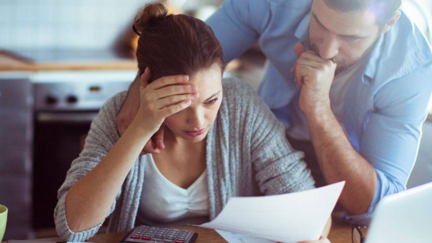 Couple looking at the rising interest rate